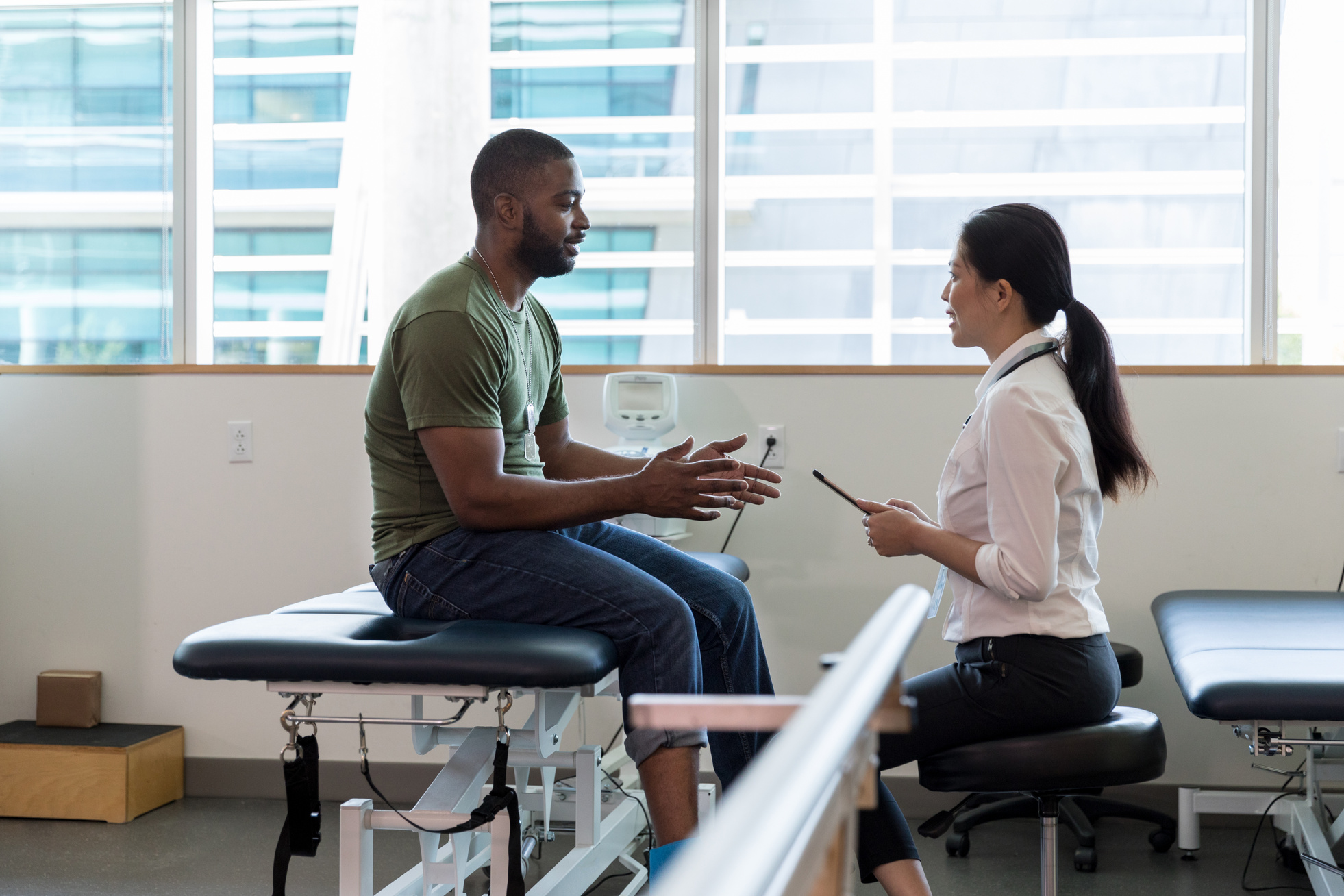 Female doctor talks with injured soldier