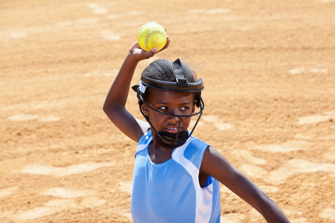 Softball player throwing ball